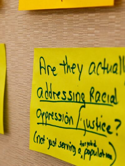 posted sign with text about racial justice and oppression