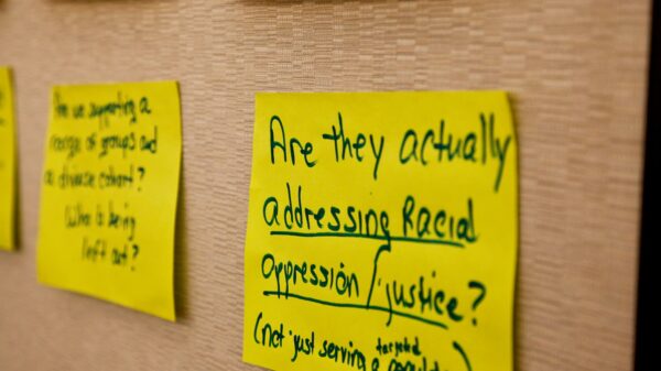 posted sign with text about racial justice and oppression