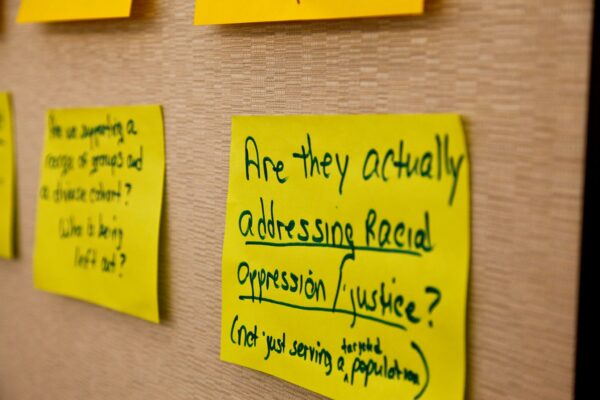 posted sign with text about racial justice and oppression