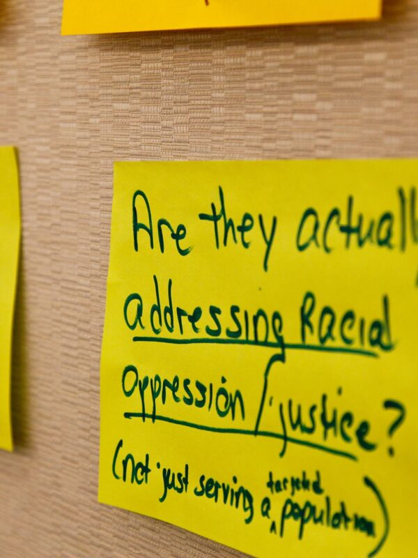 posted sign with text about racial justice and oppression
