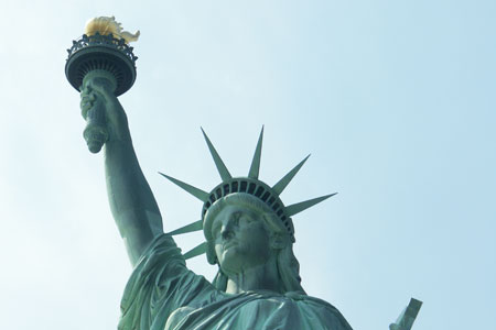 statue of liberty head and arm with torch