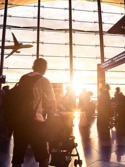 People moving through airport with luggage