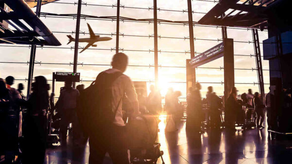People moving through airport with luggage