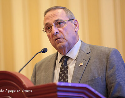 Gov. Paul LePage speaking at a podium