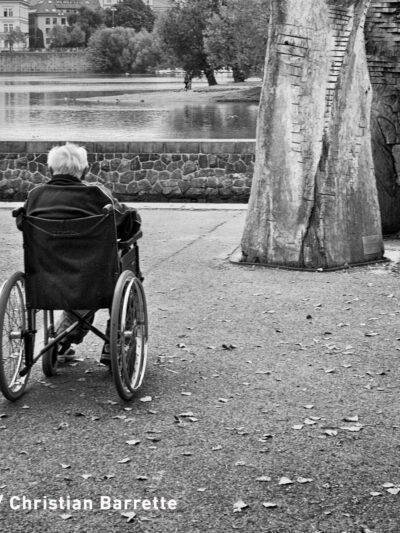 black and white photo of elderly man in wheelchair