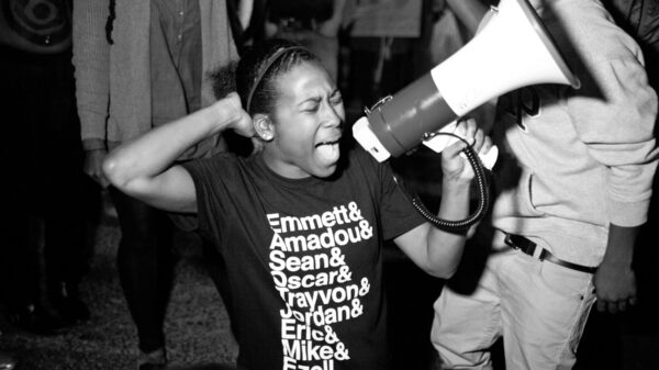 black and white film still from Whose Streets of activist with bullhorn