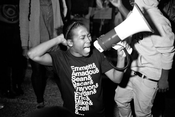 black and white film still from Whose Streets of activist with bullhorn