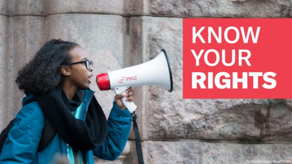 Female student with bullhorn and Know Your Rights text