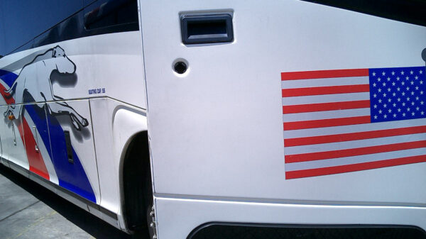 Greyhound bus with open door and American Flag decal