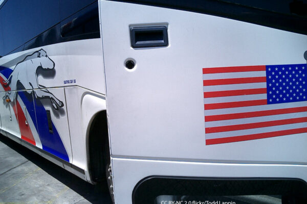 Greyhound bus with open door and American Flag decal