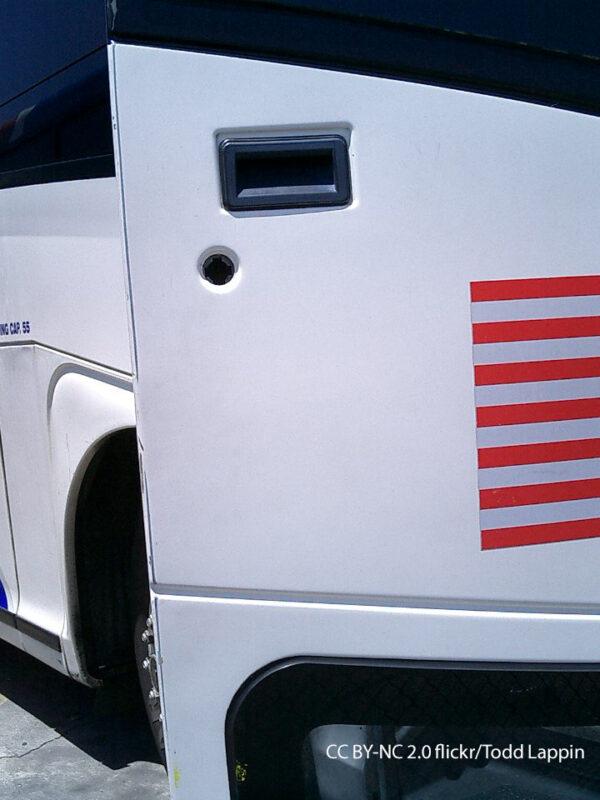Greyhound bus with open door and American Flag decal