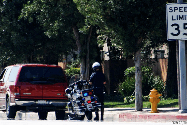 Police officer pulls car over for a traffic stop