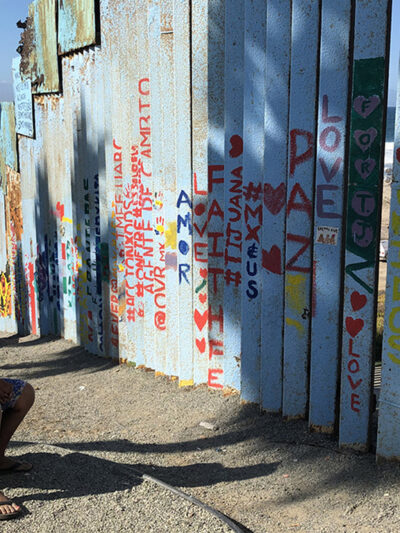 Woman seated near fence