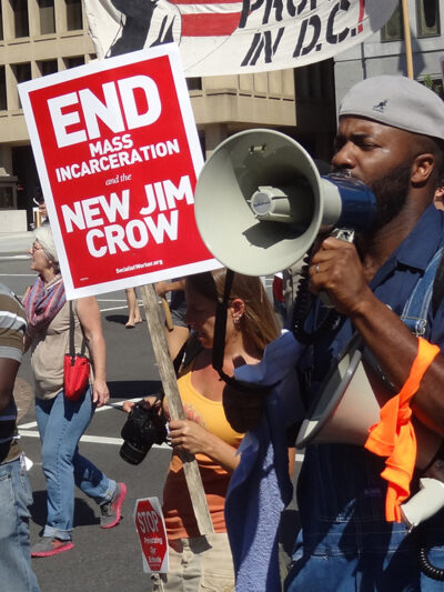 Demonstrators carry signs advocating an end to mass incarceration