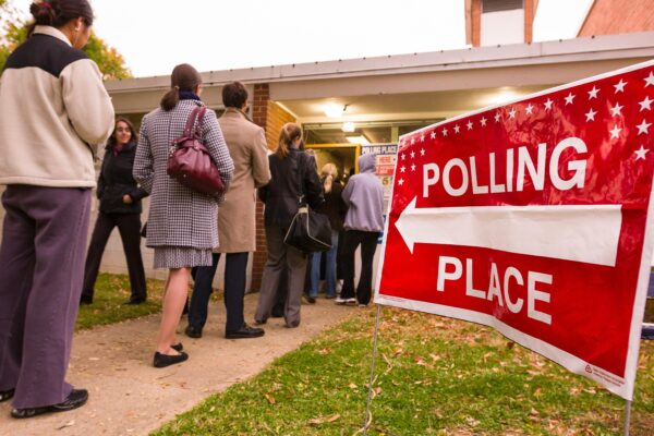 People lined up waiting to enter their polling place.