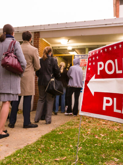 People lined up waiting to enter their polling place.