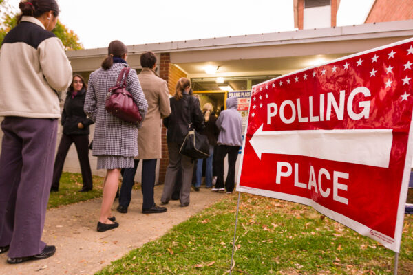 People lined up waiting to enter their polling place.