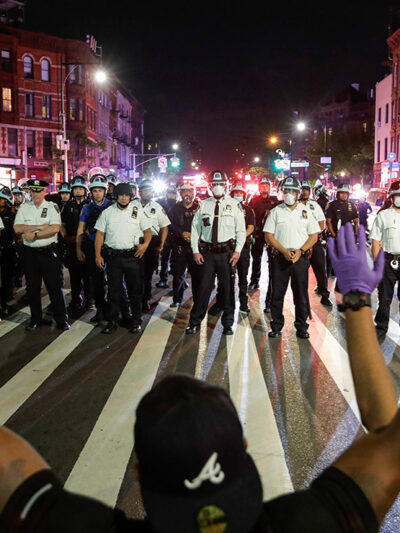 Protesters take a knee on Flatbush Avenue in front of New York City police officers during a solidarity rally for George Floyd