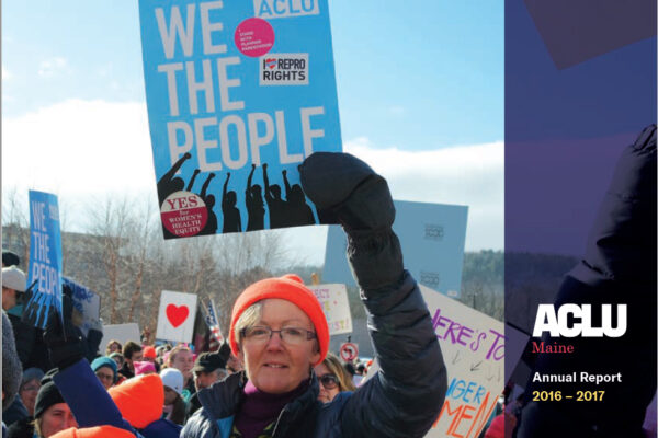 Annual Report cover with picture of woman holding blue sign that reads WE THE PEOPLE. White text in purple sidebar reads ACLU of Maine Annual Report 2016-2017