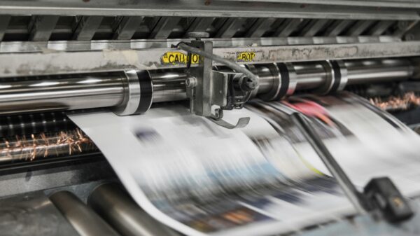 Newspaper coming off a printer