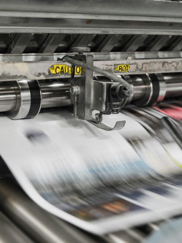 Newspaper coming off a printer
