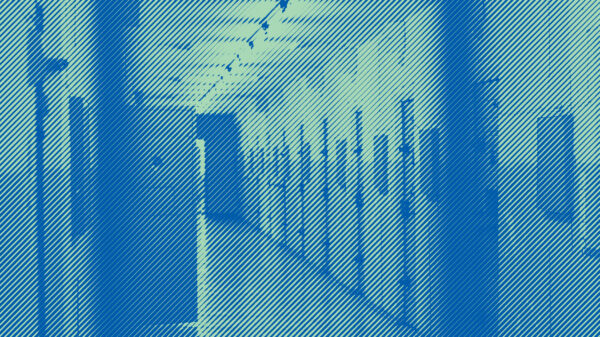 Photo of inside of jail with light blue and green duotone treatment.
