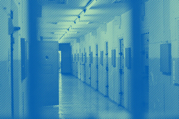Photo of inside of jail with light blue and green duotone treatment.