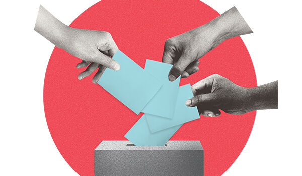 Hands putting ballots in ballot box
