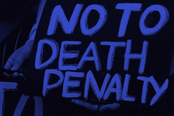 Person holding poster that reads "NO TO DEATH PENALTY"