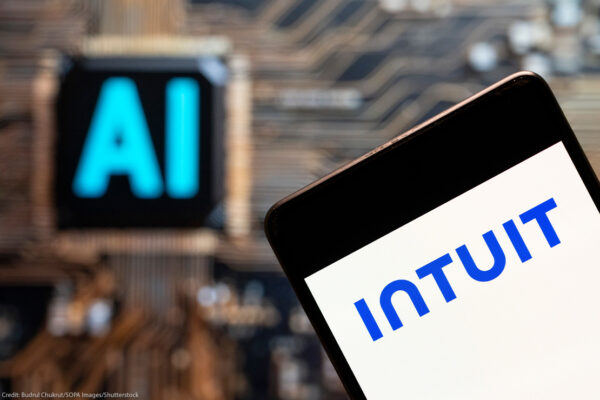 Software company Intuit logo seen displayed on a smartphone with an Artificial intelligence (AI) chip and symbol in the background.