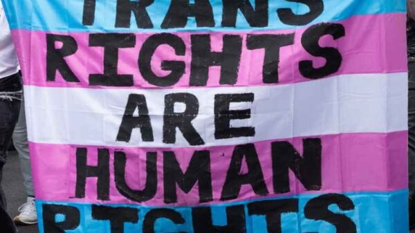 Trans Rights, speakers, protesters, and supporters denounce the Trump Administration's persistent attacks on the transgender community. by carrying a huge sign reading" TRANS RIGHTS ARE HUMAN RIGHTS".