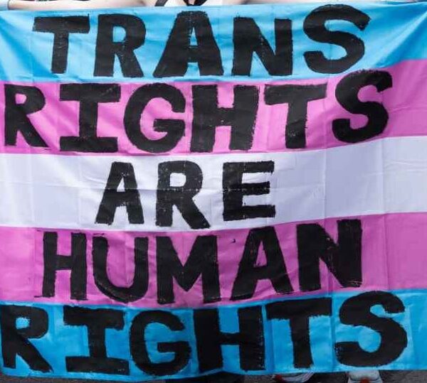 Trans Rights, speakers, protesters, and supporters denounce the Trump Administration's persistent attacks on the transgender community. by carrying a huge sign reading" TRANS RIGHTS ARE HUMAN RIGHTS".