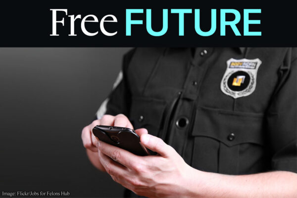 A close up of a person in a police uniform with a phone in their hands