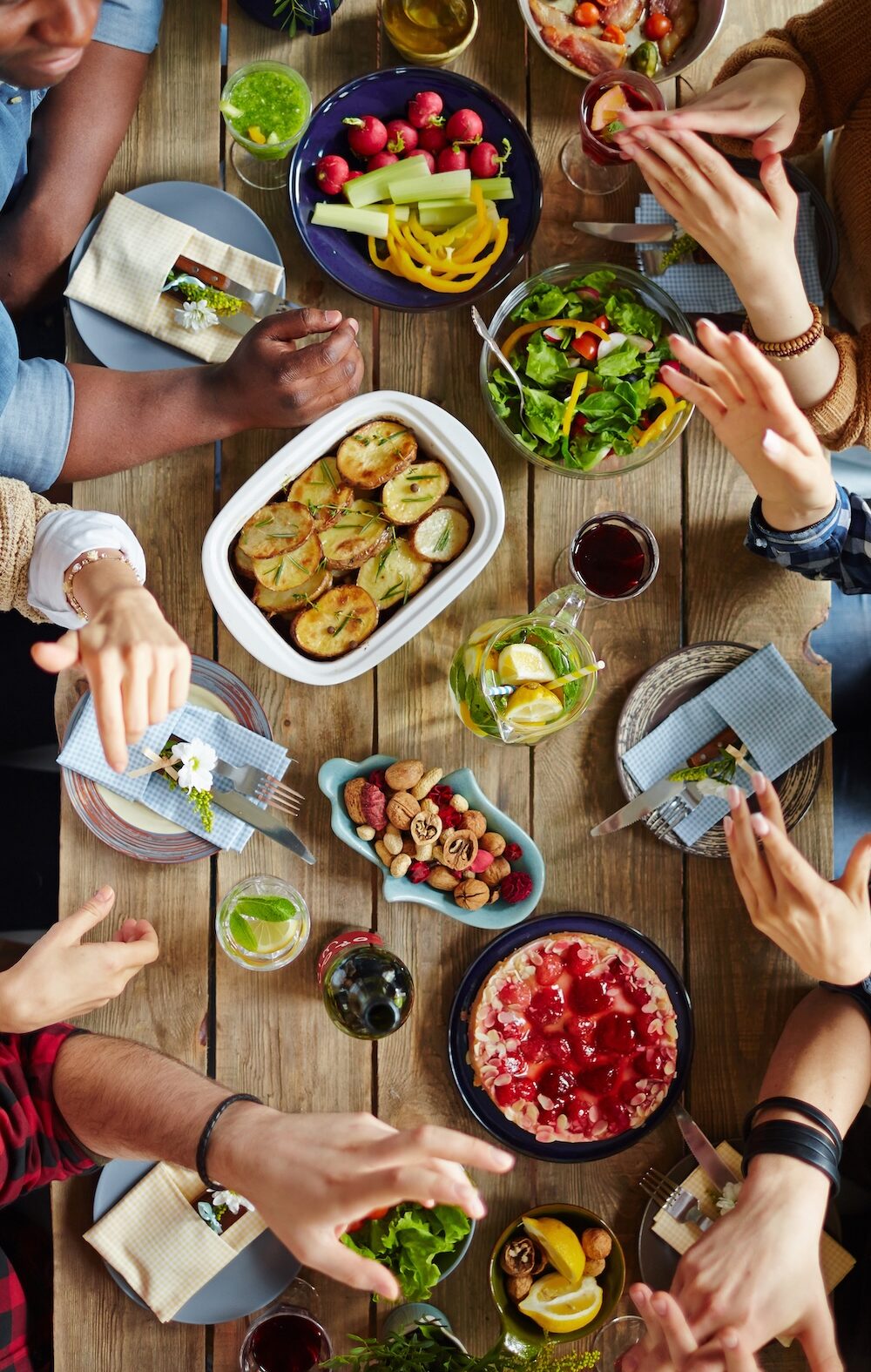A group of people have an animated conversation over a dinner table.