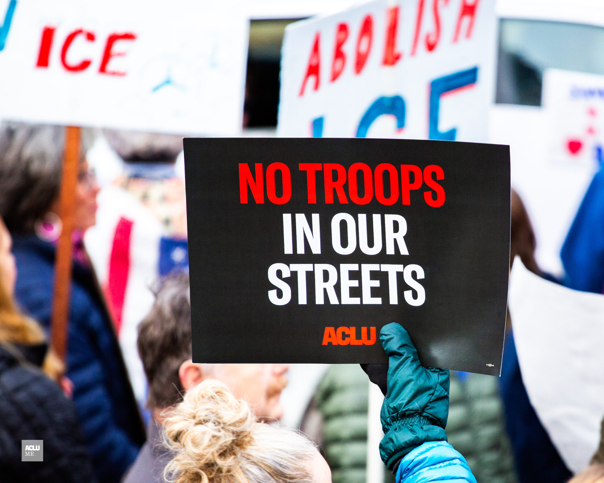 No Troops in Our Street poster at a protest in Portland, Maine.