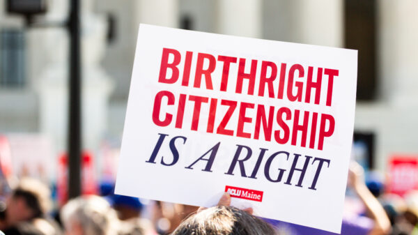 Person holding sign reading: Birthright citizenship is a right