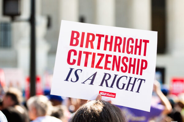 Person holding sign reading: Birthright citizenship is a right