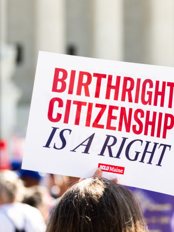 Person holding sign reading: Birthright citizenship is a right