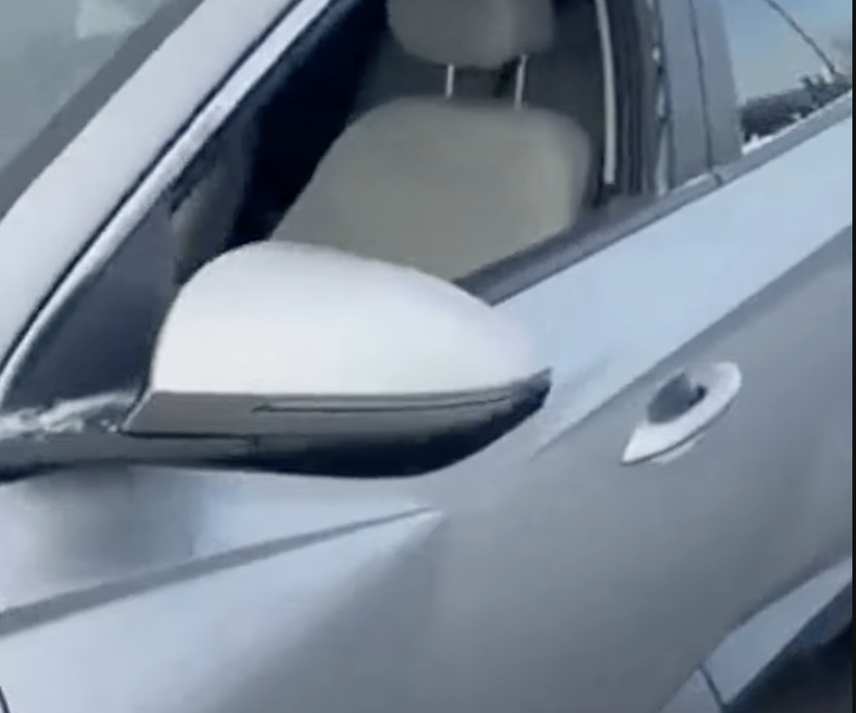 Car left on street with broken window