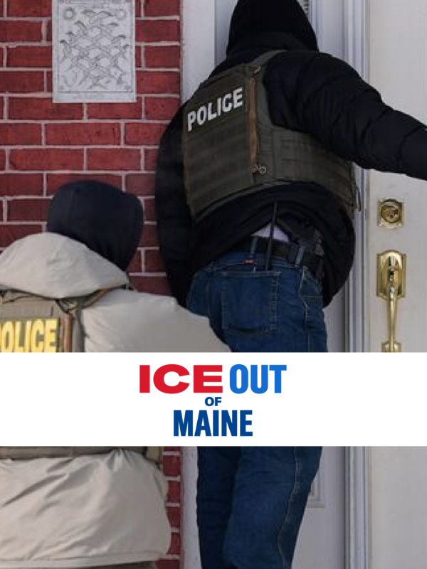 Law enforcement officers at the door of a brick home.