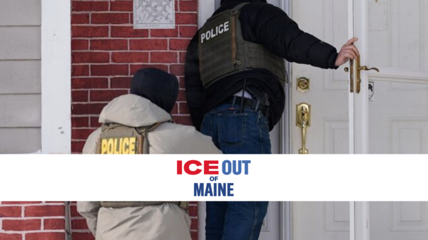 Law enforcement officer's at the door of a brick home.