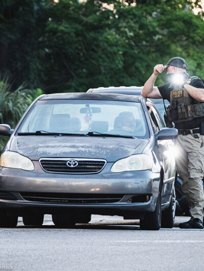 ICE agents temporarily halting a driver.