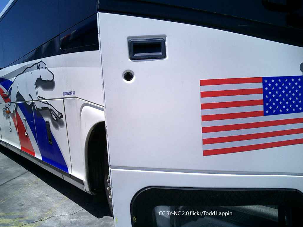 Greyhound bus with open door and American Flag decal