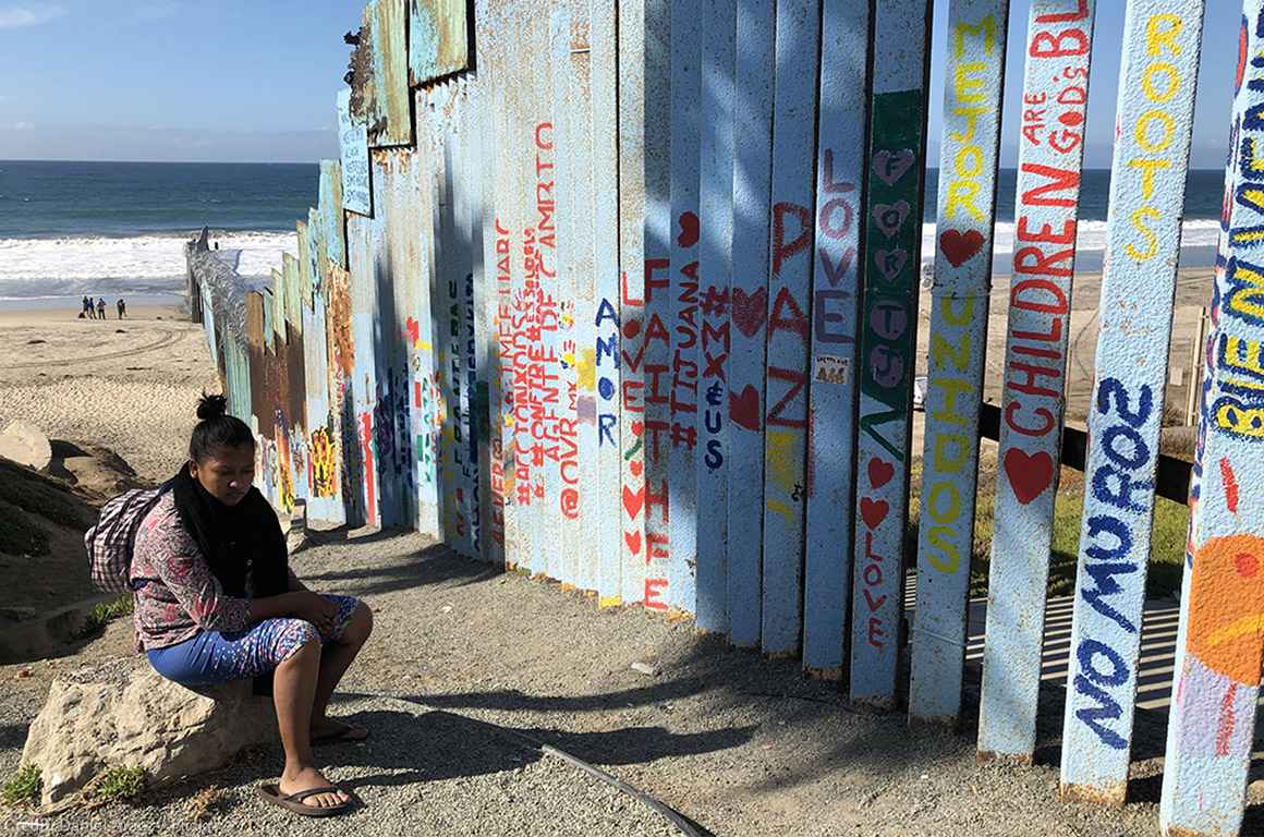 Woman seated near fence