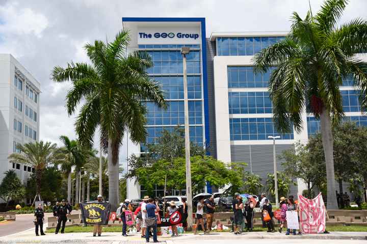 Protestors march in front of the ICE Company, The Geo Group building, demanding the end of private prisons.
