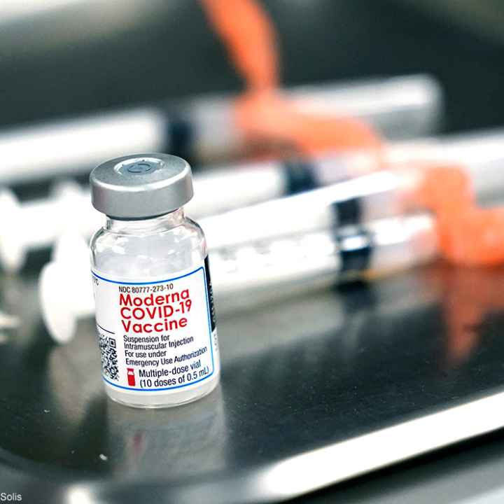 Syringes with doses of the Moderna COVID-19 vaccine on a surgical tray.