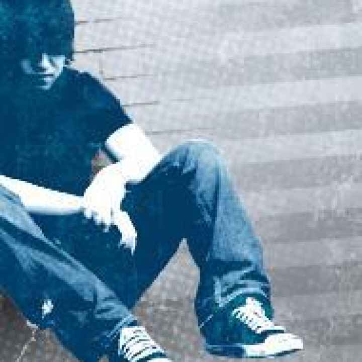 child sitting in corner with head down