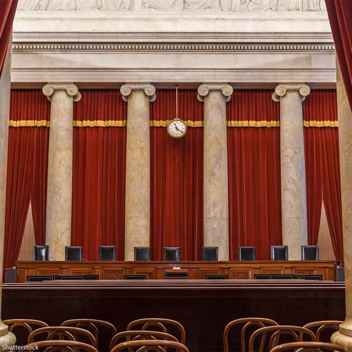 The vacant interior of the US Supreme Court with the justices' equally vacant seats.
