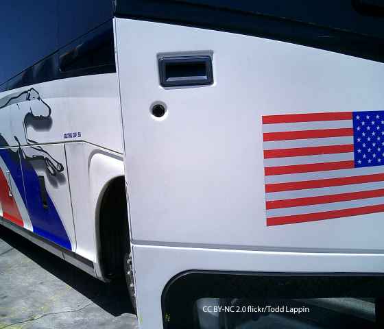 Greyhound bus with open door and American Flag decal